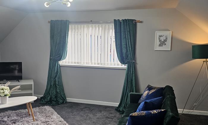 The Redford Cwtch Lounge – a cosy, welcoming space with soft seating, warm lighting, and rustic charm, perfect for relaxing with family or friends aft